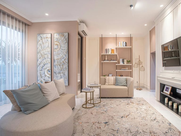 Modern living room with curved sofa, built-in shelves, and large window.