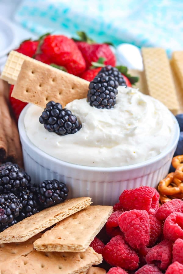 Creamy dip with berries and crackers for a snack or party.