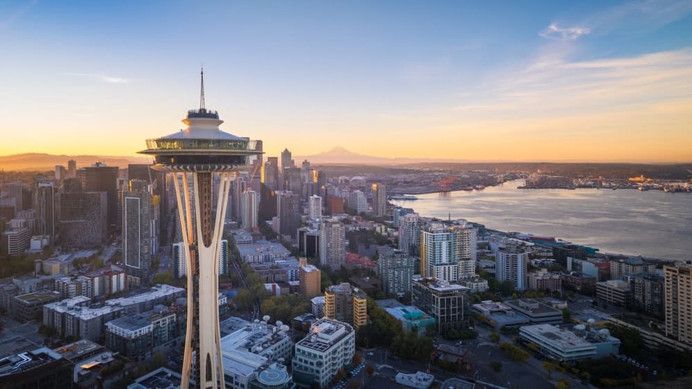 Aerial view of Seattle skyline with Space Needle at sunset.