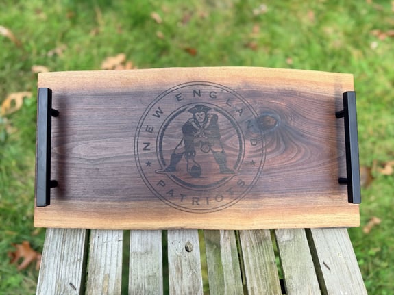Wooden serving tray with black handles and New England Patriots logo.