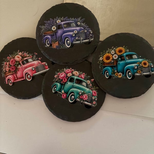 Four decorative slate coasters with vintage trucks loaded with flowers.