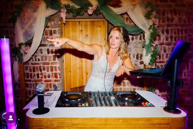 Wedding guests having fun behind the DJ booth at Fishley Hall, Acle, Norfolk, during an evening reception with Haliwaves DJ Wedding & Events