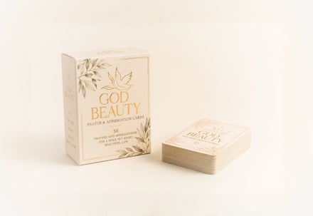 Box and deck of affirmation cards on plain background